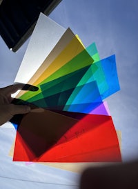 a person holding a sheet of colored paper