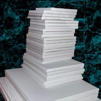 a stack of white books on top of a black background