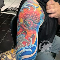 an octopus tattoo on a man's arm