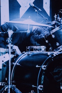 a man laying down on a drum set