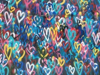 a wall with many colorful hearts painted on it