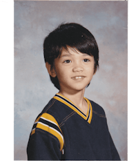a photo of a young boy in a school uniform