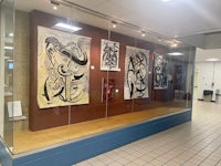 a glass display case with artwork on it