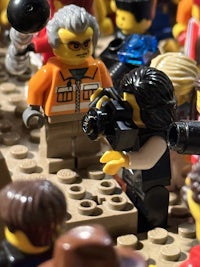a group of lego people are gathered around a table