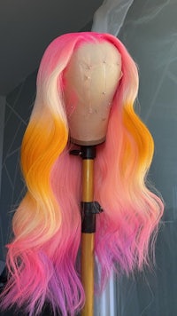a pink and orange wig on a mannequin