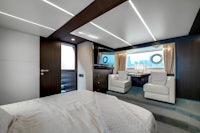 the interior of a luxury yacht with a bed and tv