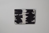 a black and white card holder on a white surface