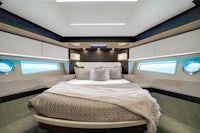 a yacht with a bed in the middle of the room
