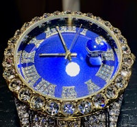 a blue watch with diamonds on it