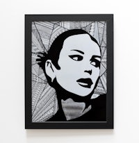 a black and white framed print of a woman's face