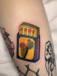 a tattoo of a matchbox with a cactus on it