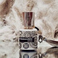 a bottle of perfume with a tassel on it