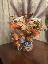 an arrangement of fall flowers on a table