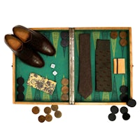 a backgammon board with a pair of shoes and a tie
