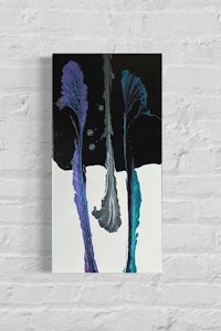 a black and purple painting on a brick wall