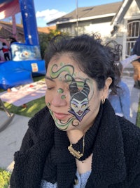 a woman with a clown face painted on her face