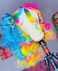 a rainbow colored wig on a mannequin
