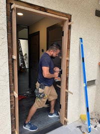 a man is installing a door in a house
