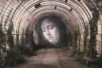 an image of a woman in a tunnel covered in ivy
