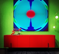 a red dresser in a room with green walls