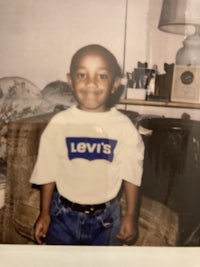 a photo of a young boy in jeans and a t - shirt